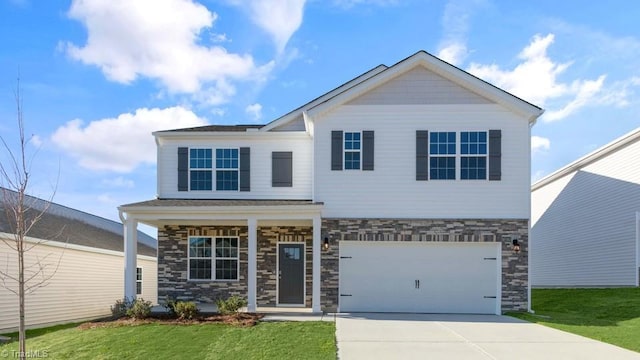 view of front of property featuring a garage, a front lawn, and a porch