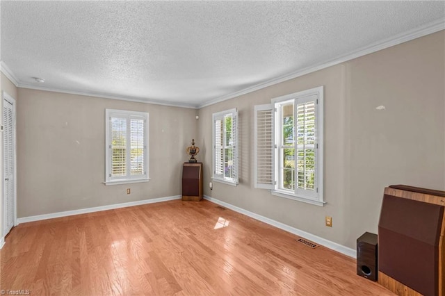 422 Wildwood Dr, Salisbury, NC 28146 - interior space featuring visible vents, ornamental molding, light wood-type flooring, baseboards, and a textured ceiling