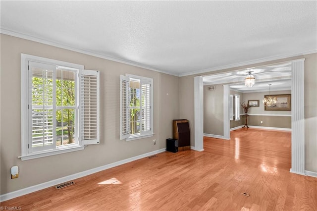 422 Wildwood Dr, Salisbury, NC 28146 - spare room featuring light wood-type flooring, baseboards, visible vents, and ornamental molding