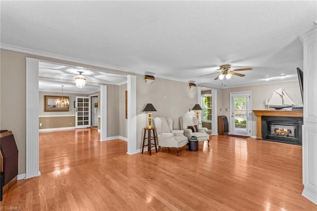 422 Wildwood Dr, Salisbury, NC 28146 - living area featuring a fireplace with flush hearth, light wood-style flooring, a textured ceiling, and crown molding
