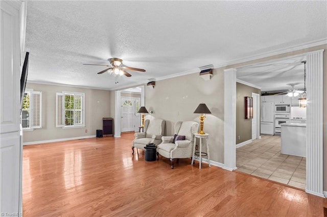 422 Wildwood Dr, Salisbury, NC 28146 - sitting room featuring a textured ceiling, baseboards, light wood-style floors, a ceiling fan, and crown molding