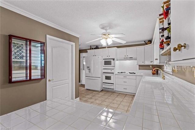422 Wildwood Dr, Salisbury, NC 28146 - kitchen with a sink, tile countertops, white appliances, ceiling fan, and ornamental molding