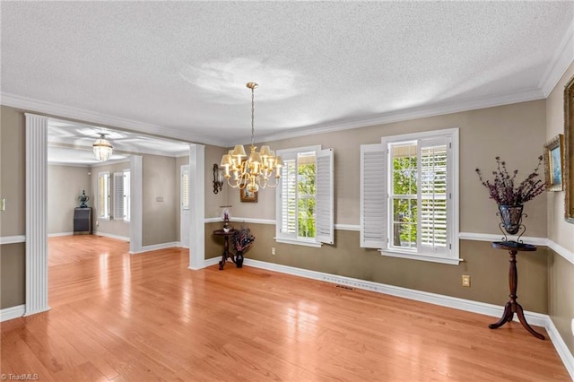 422 Wildwood Dr, Salisbury, NC 28146 - unfurnished dining area featuring light wood-type flooring, an inviting chandelier, and a textured ceiling