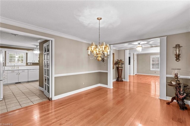 422 Wildwood Dr, Salisbury, NC 28146 - unfurnished dining area featuring light wood-type flooring, a textured ceiling, crown molding, and ceiling fan with notable chandelier