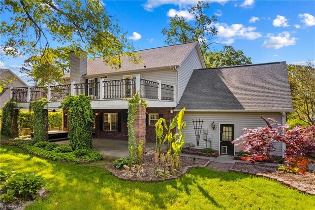 422 Wildwood Dr, Salisbury, NC 28146 - rear view of property with a yard, a patio area, a shingled roof, and a chimney