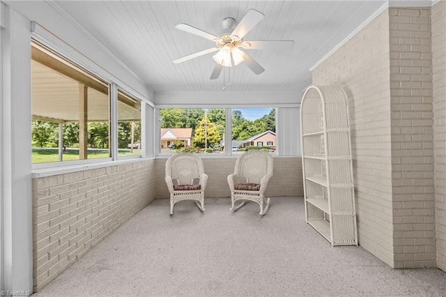 sunroom featuring ceiling fan and a wealth of natural light