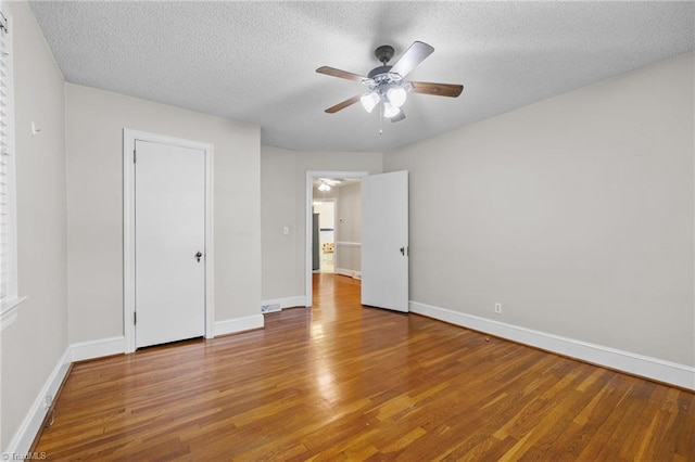 unfurnished bedroom featuring ceiling fan, hardwood / wood-style floors, and a textured ceiling