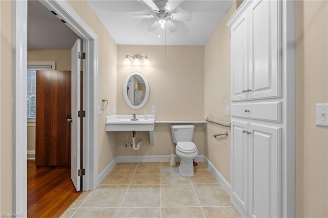 bathroom featuring ceiling fan, sink, wood-type flooring, and toilet