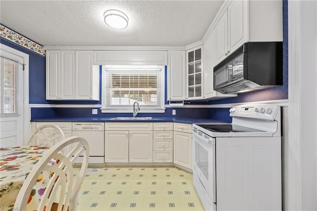 kitchen featuring white cabinets, white appliances, sink, and a textured ceiling