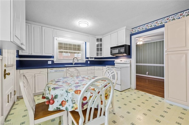 kitchen featuring white cabinetry, sink, ceiling fan, a textured ceiling, and white appliances