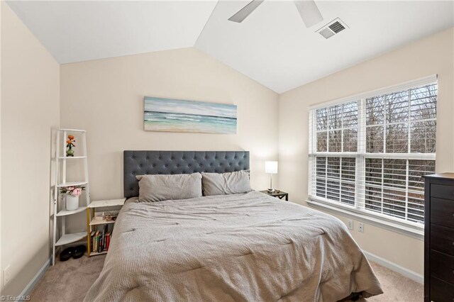 carpeted bedroom with ceiling fan and lofted ceiling