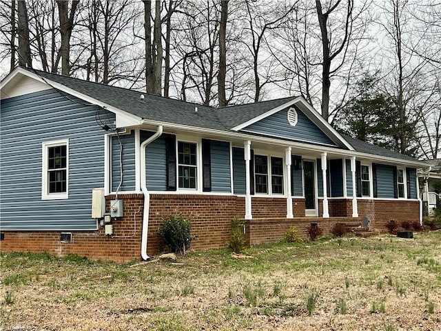 view of front of property with a porch, brick siding, and crawl space