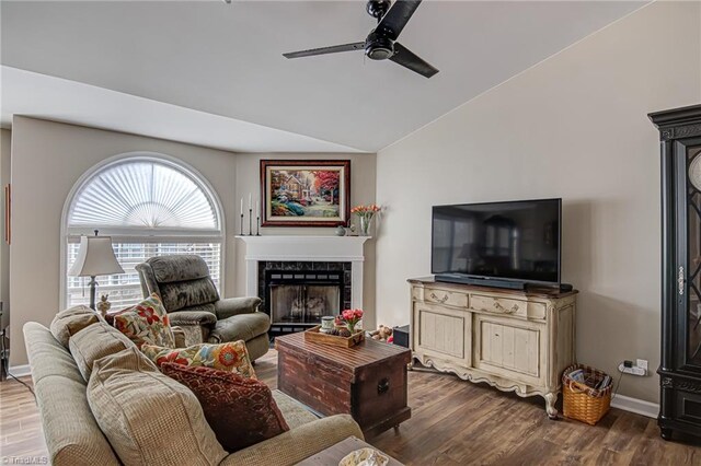 living room with a fireplace, wood-type flooring, ceiling fan, and lofted ceiling