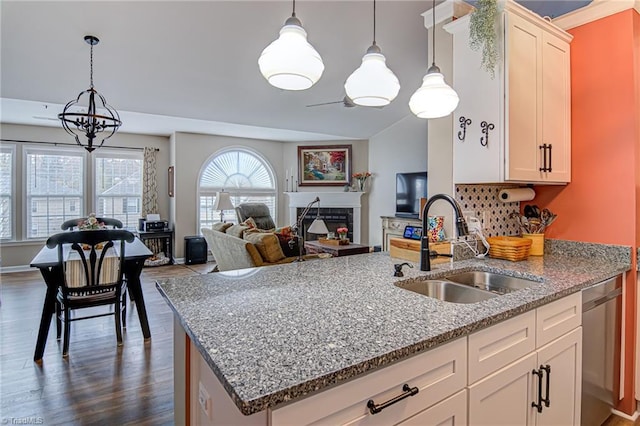 kitchen with sink, white cabinets, stainless steel dishwasher, and dark hardwood / wood-style floors