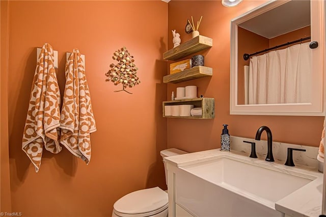 bathroom featuring vanity and toilet