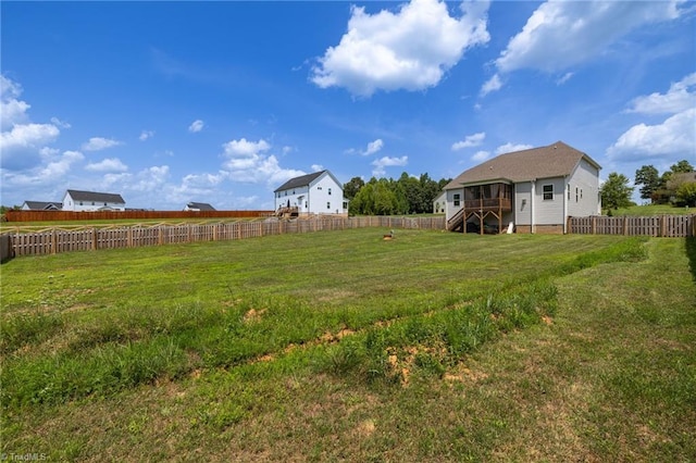 view of yard featuring a fenced backyard and stairs