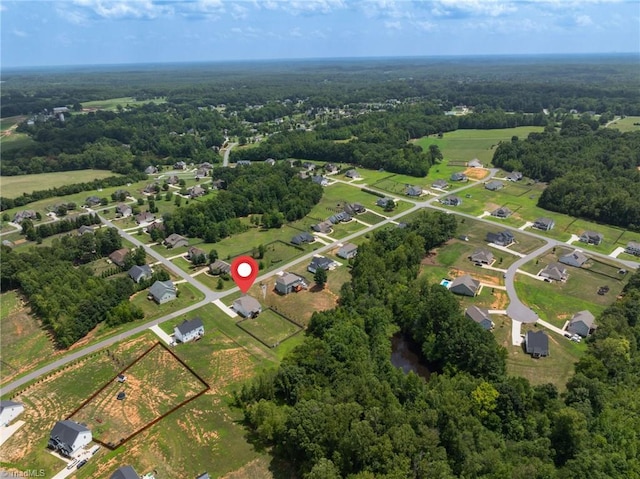 drone / aerial view featuring a forest view