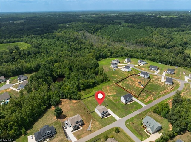 drone / aerial view featuring a forest view