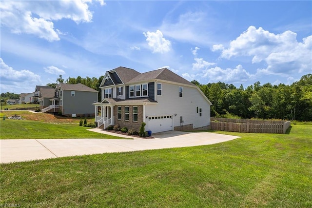 view of side of home with a garage, concrete driveway, a yard, and fence