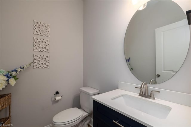 bathroom featuring toilet and vanity