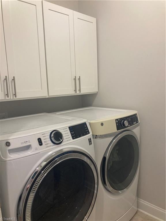 laundry area featuring cabinets and washer and dryer