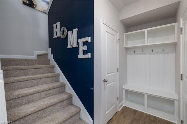 stairway featuring wood finished floors and baseboards