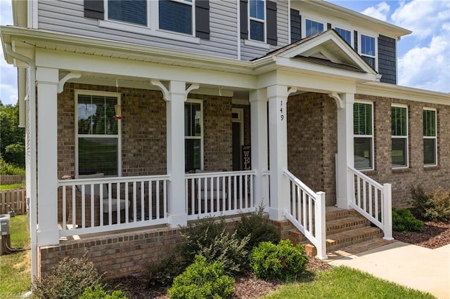 view of exterior entry with covered porch