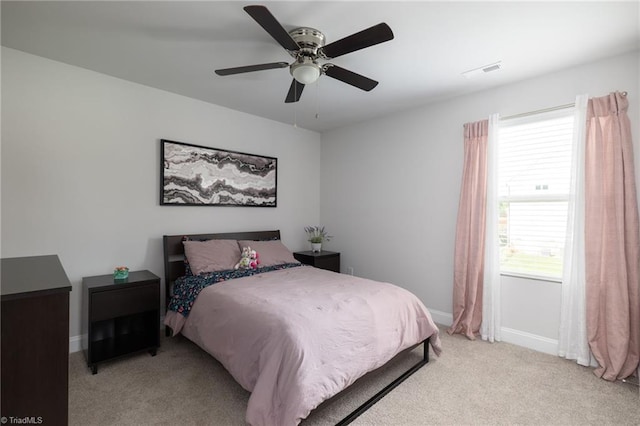 bedroom featuring light carpet, baseboards, visible vents, and ceiling fan