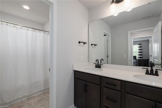 bathroom featuring tile patterned flooring and double vanity