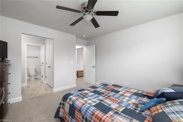 bedroom featuring light carpet, ceiling fan, ensuite bath, and baseboards