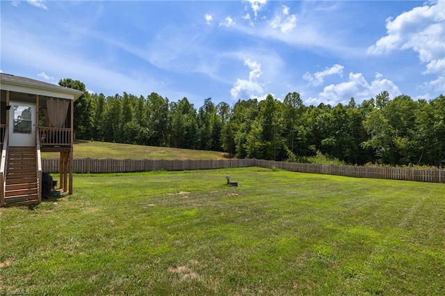 view of yard featuring stairs and fence