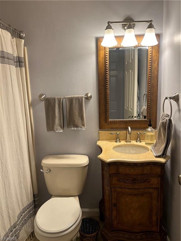 bathroom with vanity, toilet, and a shower with shower curtain