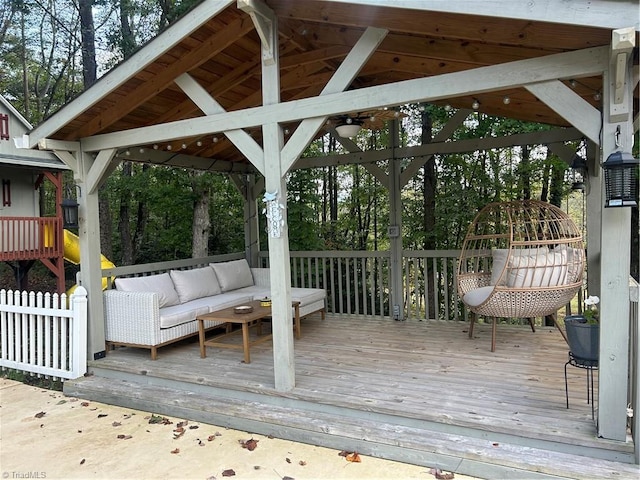 wooden terrace with an outdoor hangout area and a gazebo