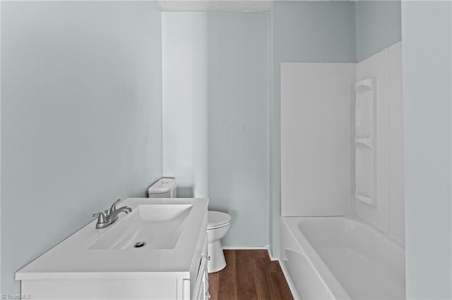 bathroom featuring vanity, shower / tub combination, wood finished floors, and toilet