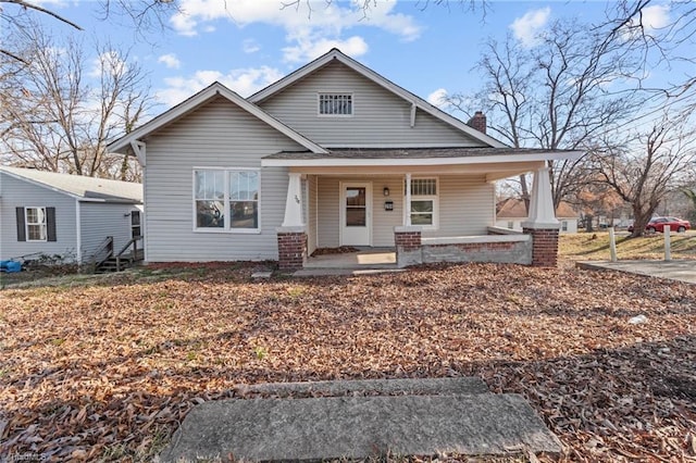 view of front of home featuring a porch and a chimney