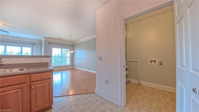 200 Lennox Dr Unit 3C, Jamestown, NC 27282 - kitchen with baseboards, light flooring, crown molding, a sink, and light countertops