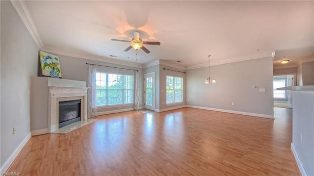 200 Lennox Dr Unit 3C, Jamestown, NC 27282 - unfurnished living room featuring a fireplace, plenty of natural light, light wood finished floors, baseboards, and crown molding
