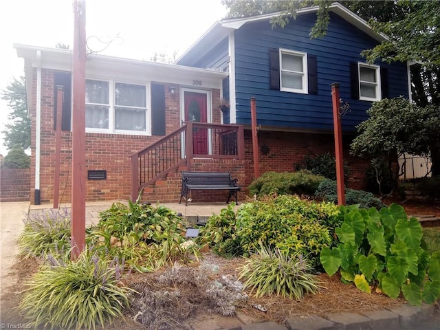 split level home featuring crawl space and brick siding