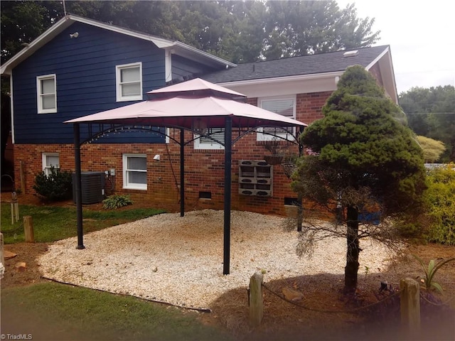 view of home's exterior featuring cooling unit and a gazebo