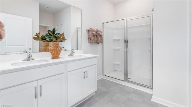 bathroom with a shower with shower door and vanity