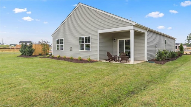 back of house featuring a patio area and a yard