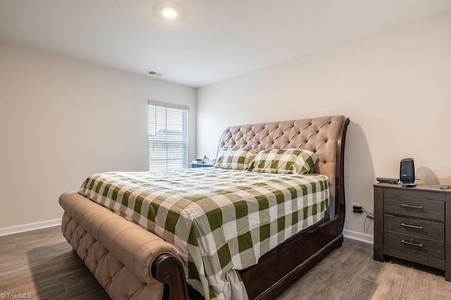 bedroom with wood-type flooring