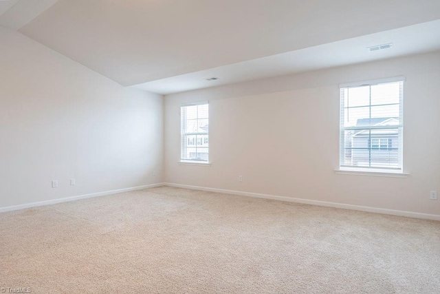 unfurnished room featuring light colored carpet