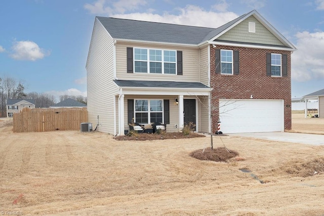 view of front of house with a garage and central AC unit