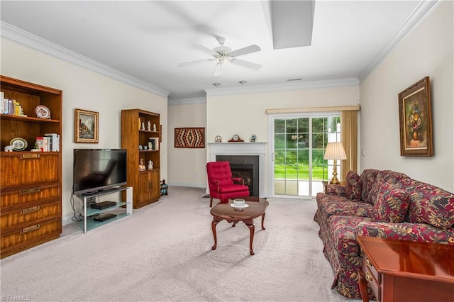 living area featuring carpet floors, a fireplace with flush hearth, crown molding, and ceiling fan