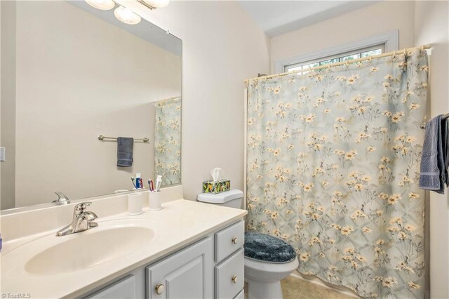 bathroom featuring vanity, toilet, tile patterned floors, and a shower with shower curtain