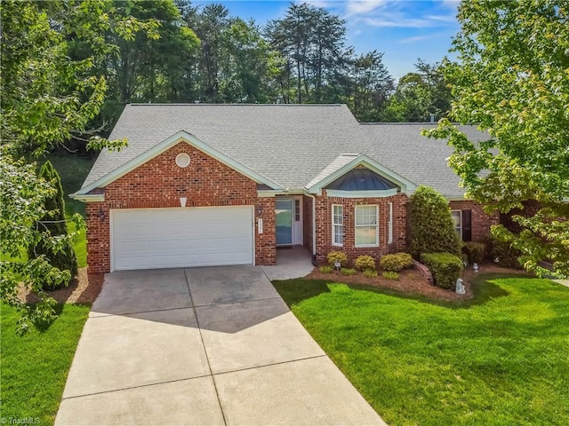 ranch-style house featuring an attached garage, a front lawn, roof with shingles, and driveway