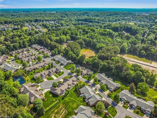birds eye view of property with a view of trees and a residential view