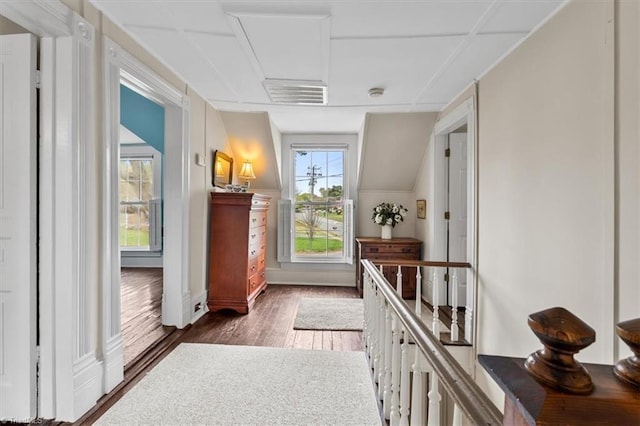 hall with wood finished floors and visible vents
