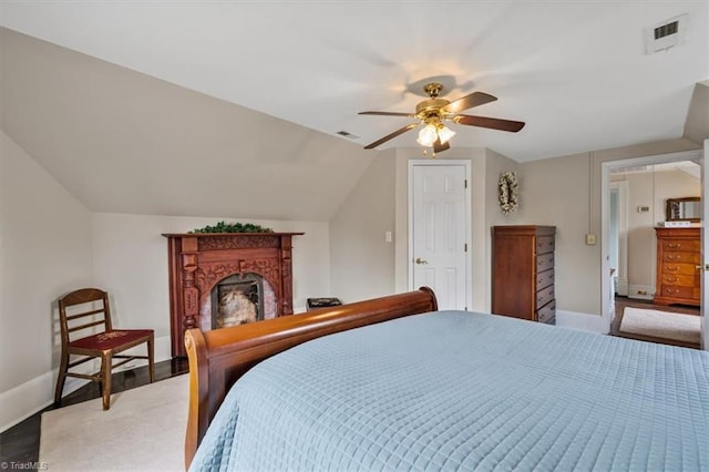 bedroom featuring ceiling fan, baseboards, lofted ceiling, and visible vents